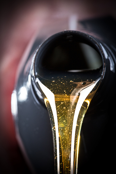 Close-up of AMSOIL motor oil pouring from a bottle